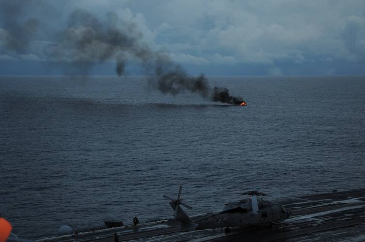 A fire destroys a fishing boat in the Atlantic Ocean as seen from the aircraft carrier USS Theodore Roosevelt (CVN 71) about 90 miles off the coast of Florida. (U.S. Navy photo by William Spears)
