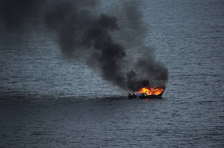 A fire destroys a fishing boat in the Atlantic Ocean about 90 miles off the coast of Florida. (U.S. Navy photo by William Spears)