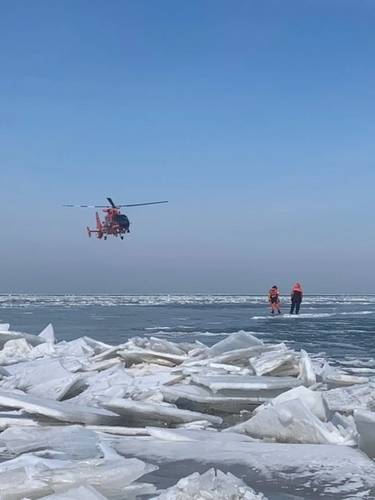 A helicopter from Coast Guard Air Station Detroit assists with the mass rescue of 46 people from an ice floe near Catawaba Island, March 9, 2019. 46 people were rescued by Coast Guard and local agencies after an ice floe broke free from land. (U.S. Coast Guard Photo)