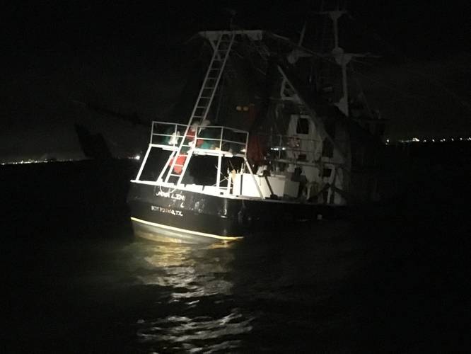 A shrimp boat sits grounded on South Galveston Jetty after three fisherman aboard were rescued by the Coast Guard. (U.S. Coast Guard photo by Tracy Mannes)