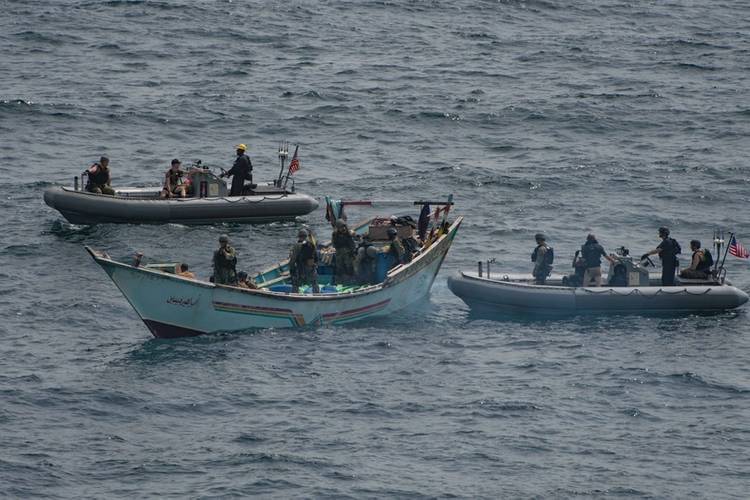 A visit, board, search and seizure team from the USS Jason Dunham (DDG 109) inspects a skiff found to be carrying a shipment of over 1,000 illicit weapons. (U.S. Navy photo by Matt Bodenner)