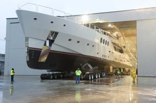 After a trek that often involved steering with only inches of clearance and a complex 90-degree turn, Chris Holland, president of HMR Supplies, moves this new 215-foot, 480-ton superyacht out of the fabrication facility and to the barge for its initial launch and sea trials.