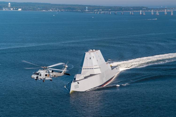 An MH-60R Sea Hawk helicopter assigned to Air Test and Evaluation Squadron (HX) 21 flies near the guided-missile destroyer USS Zumwalt (DDG 1000) as the ship travels to its new home port of San Diego. (U.S. Navy photo by Liz Wolter)