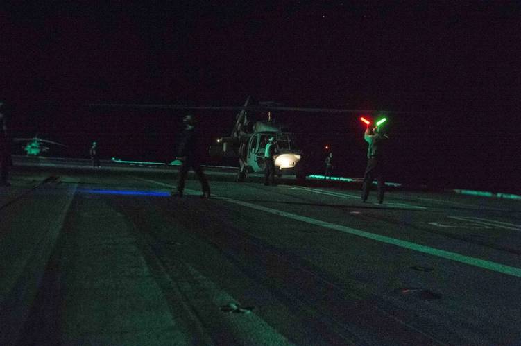 An MH-60S Sea Hawk helicopter assigned to the Tridents of Helicopter Sea Combat Squadron (HSC) 9 undergoes pre-flight checks on the flight deck of the aircraft carrier USS Dwight D. Eisenhower (CVN 69) before departing the ship to rescue distressed mariners. (U.S. Navy photo by Taylor L. Jackson)