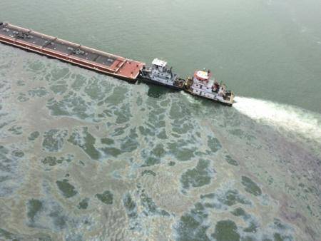 A barge loaded with marine fuel oil sits partially submerged in the Houston Ship Channel, March 22, 2014. The bulk carrier Summer Wind, reported a collision between the Summer Wind and a barge, containing 924,000 gallons of fuel oil, towed by the motor vessel Miss Susan. (USCG photo)