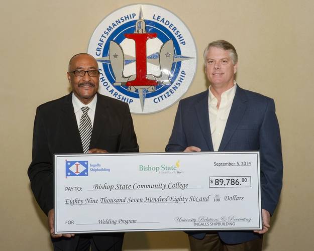 Brian Cuccias (right), president of Ingalls Shipbuilding, presents a check for $89,786.90 to James Lowe Jr., president of Bishop State Community College. The money will be used to purchase 20 welding machines and wire feeder boxes for the school’s welding technology program. Photo by Lance Davis/HII