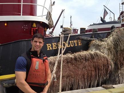 Cadet Joel Amendolara at McAllister’s Yard in Staten Island, alongside the bow of the tug RESOLUTE. Cadet Amendolara was aboard the tug for ten days.