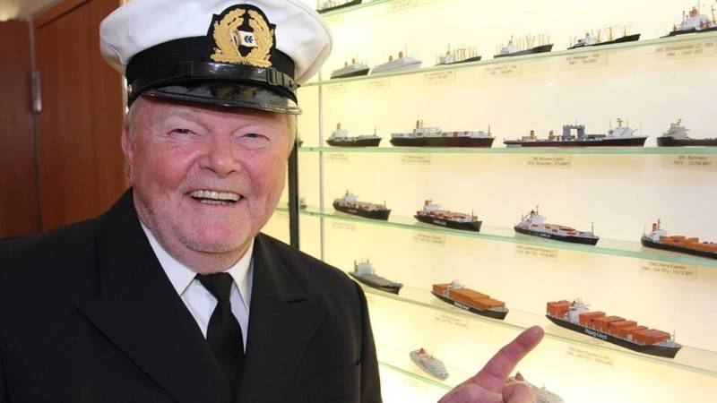 Captain Siegfried Schmerer points to a model of the Bonn Express. It was the first ship he has ever captained. (Photo: Hapag-Lloyd)