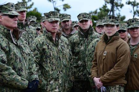 Lt. Meng Lin, (Center), asks a question during a security briefing regarding the role of Port Security Unit (PSU) 313 during a Combined Joint Logistics Over-the-Shore Exercise (CJLOTS), April 15, 2013. (U.S. Coast Guard photo by Petty Officer