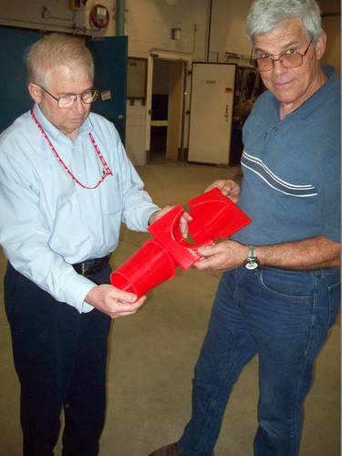 Chuck Ryerson and Len Zabilansky at the lab. They are holding a 3-D printed test article for understanding the effects of frazil ice in a water jet propulsion system.