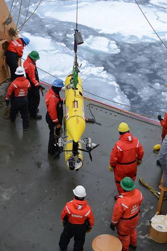 Coast Guard Cutter Healy deckhands prepare to lower an unmanned underwater vehicle, operated by the Woods Hole Oceanographic Institute, into the Beaufort Sea. WHOI scientists used the UUV to monitor ice conditions from below during the simulated exercise. (U.S. Coast Guard photo by Petty Officer 3rd Class Grant DeVuyst)