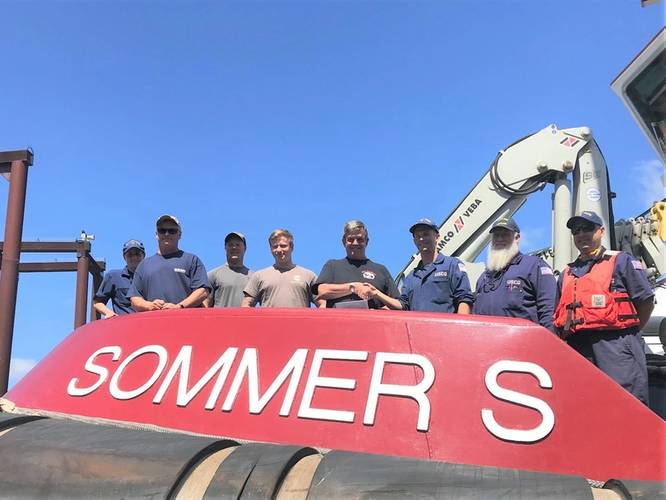 Coast Guard marine inspectors from Marine Safety Unit Portland, present a Subchapter M Certificate of Compliance to the crew of the towing vessel Sommer S., operated by Shaver Transportation, in Portland, Ore., July 20, 2018. (U.S. Coast Guard photo by Lt. Anthony Solares)