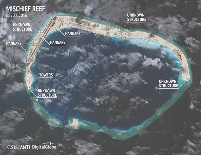 Construction of hangars at Mischief Reef is at an earlier stage. Small hangars are being built along the length of the runway, while three medium hangars and one large hangar are being constructed along the apron at its northern end. (Image courtesy: “CSIS Asia Maritime Transparency Initiative/DigitalGlobe”)