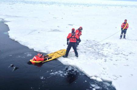 Crew members of Coast Guard Cutter Katmai Bay, homeported in Sault Ste. Marie, Mich., practice ice rescue techniques in the Straits of Mackinac Feb. 4, 2014. (U.S. Coast Guard photo by Seaman Paul Walker)