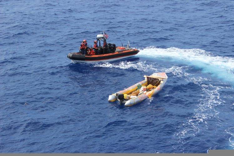 The Cutter Dauntless smallboat crew inspects a rustic vessel used by 20 Cuban migrants south of Dry Tortugas, Florida, Sep. 6, 2014. The migrants were later repatriated by the crew aboard the Coast Guard Cutter Knight Island. U.S. Coast Guard photo.