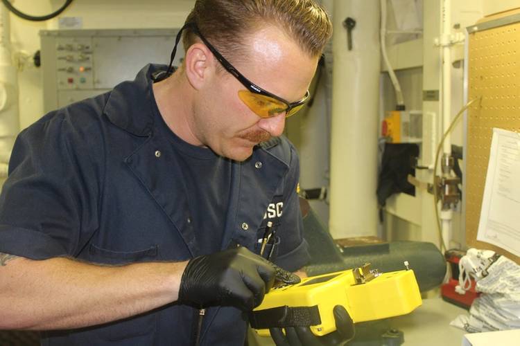 Cutter engineer receives immediate oil analysis results (Photo courtesy USCG)