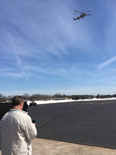 Dave Martin of Neya Systems uses an Android tablet to control both an unmanned aircraft and ground vehicle at the same time. (Neya Systems photo)