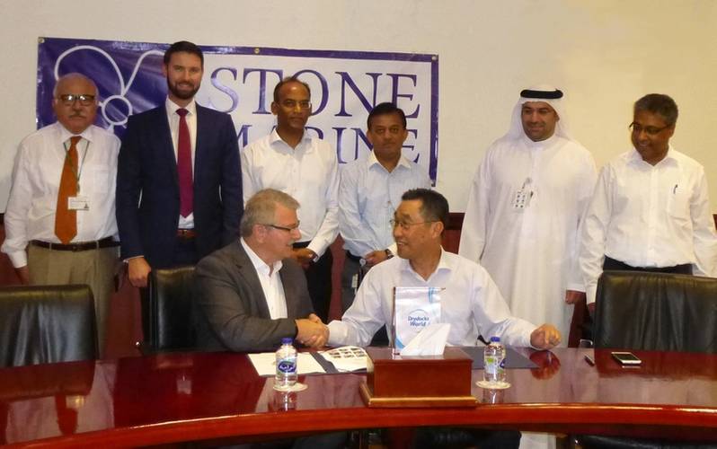 DDW Chief Operations Officer, Mohammad Rizal, shaking hands with Don Quilliam, Managing Director of Stone Marine Shipcare Ltd., with senior executives from both company’s looking on. (Photo: Stone Marine Shipcare)