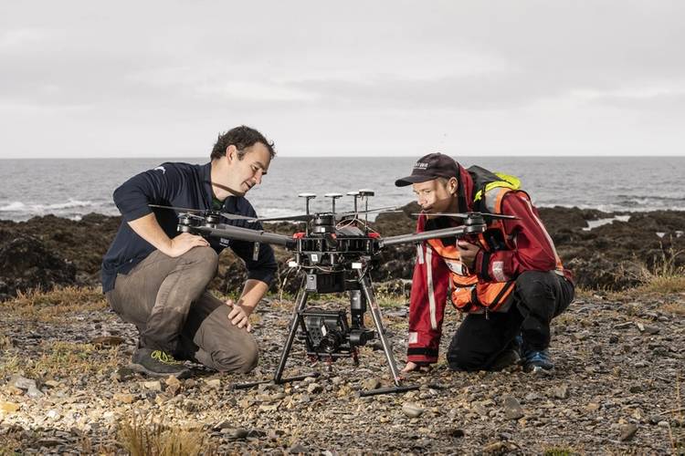 Drone pilot Hamish Sutton (left) and Dr Leigh Tait check settings before launching another pre-programmed flight across the Taputeranga Marine Reserve. © Rebekah Parsons-King, NIWA