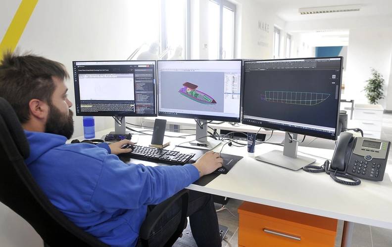 An engineer adds custom features to a Metal Shark center console law enforcement vessel at Metal Shark Croatia.