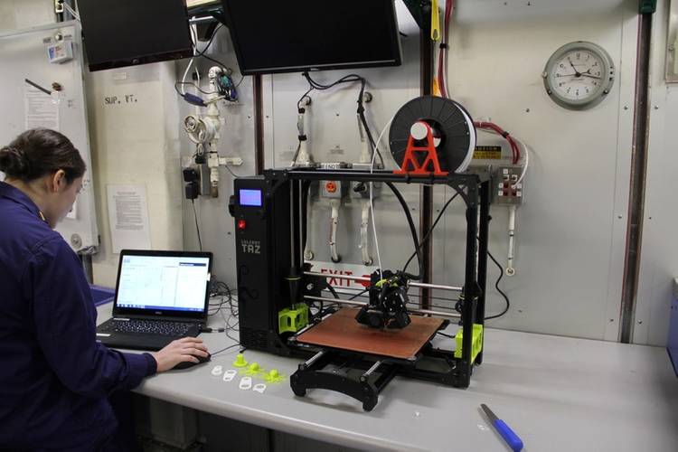 Ensign Abigail Isaacs uses a 3-D printer aboard Coast Guard Cutter Healy (U.S. Coast Guard photo)