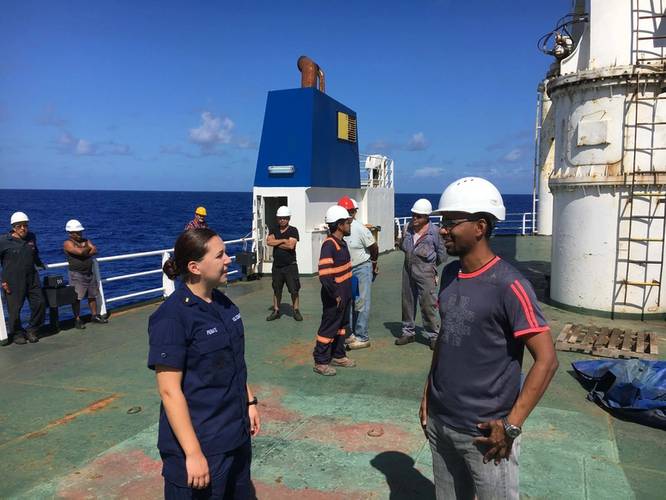 Ensign Samantha Penate, from the Coast Guard Cutter Confidence, speaks with the master of Alta to determine the situation aboard their disabled cargo ship in the Atlantic Ocean, October 7, 2018. The ship became disabled more than 1,000 miles from shore on September 19. U.S. (Coast Guard photo by Todd Behney)