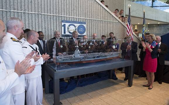 Representatives of Newport News Shipbuilding unveil a model of the aircraft carrier Gerald R. Ford (CVN 78) at the Gerald R. Ford Museum in Grand Rapids, Mich. Pictured with the shipbuilders are Susan Ford Bales, right, the ship’s sponsor and President Ford’s daughter, and representatives of the ship’s crew. (U.S. Navy photo courtesy of Newport News Shipbuilding by Ricky Thompson/Released)