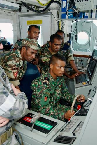 Timor-Leste Defense Force (F-FDTL) representatives inspect HMAS Diamantina's bridge navigation equipment during their time at sea onboard the Royal Australian Navy Minehunter. (Photo: Ben Catterall)