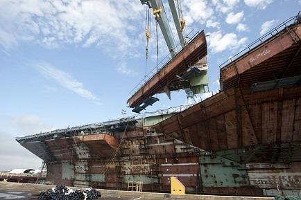 Newport News Shipbuilding's 1,050-metric ton gantry crane lifts the forward end of one of aircraft carrier Gerald R. Ford's (CVN 78) catapults into place, bringing more than three years of structural erection work to a close. Photo courtesy of Huntingdon Ingalls Industries
