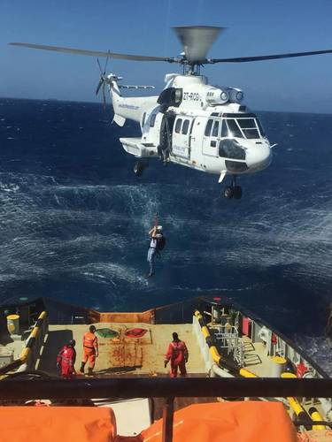 Joey Farrell is lowered via helicopter to a firefighting tug off Grand Canary. Photo courtesy Resolve Marine Group.