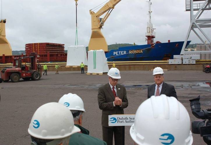 First handful of cooling units being offloaded during today’s media briefing at the Duluth Seaway Port Authority’s Clure Public Marine Terminal with Dave McMillan (L), senior vice president of external affairs at ALLETE and executive vice president of Minnesota Power, along with Vanta E. Coda II (R), executive director of the Duluth Seaway Port Authority speaking in the foreground.