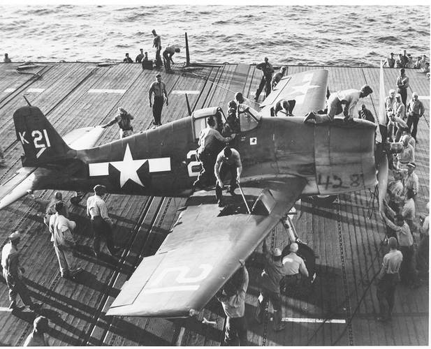 Flight Deck Crew Swarm Over an F6F Hellcat - July 1944. (Photo: U.S. Navy’s National Museum of Naval Aviation, Pensacola, Fla.)