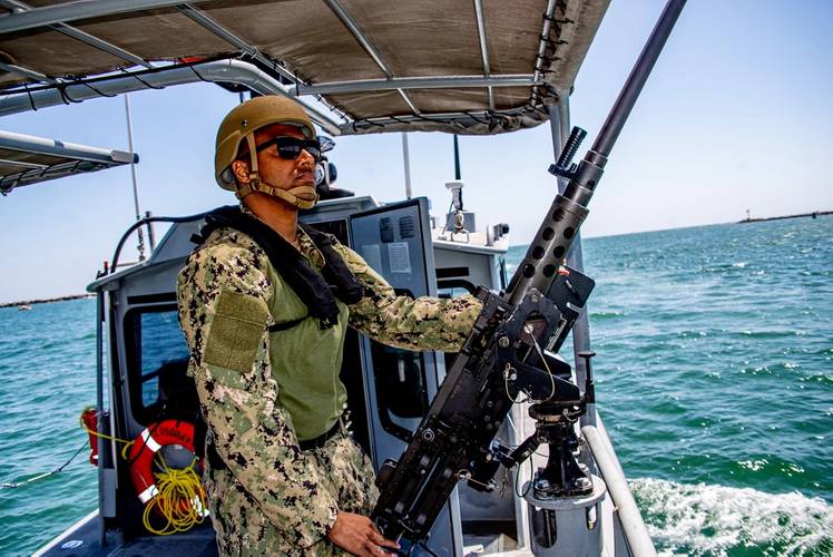 Hospital Corpsman 2nd Class assigned to Maritime Expeditionary Security Squadron (MSRON) 11 manned a .50 cal. machine gun onboard 34-foot patrol boat during out bound transit as part of Maritime Expeditionary Security Force (MESF) Boat University (BU) Tactical Craft Crewman/Gunner along Seal Beach harbor, Calif. MESF BU is designed to train and qualify the MESF to sustain mobilization readiness. MESF is a core Navy capability that provides port and harbor security, high value asset security, and