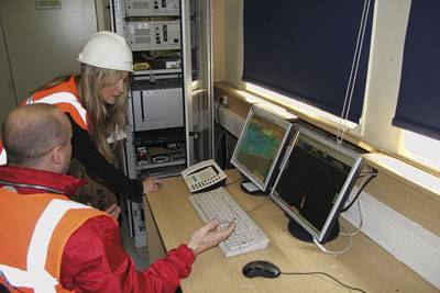 IT staff maintain computers in the ship’s server room
