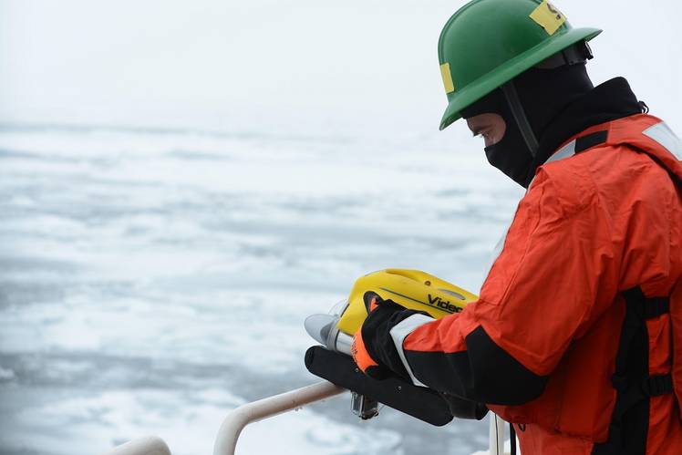 Jason Story, a project manager with the Coast Guard Research and Development Center, prepares to deploy a Coast Guard Marine Safety and Security Team remotely operated vehicle aboard the Coast Guard Cutter Healy. The ROV worked in tandem with other multi-agency unmanned and remote technologies in the first exercise of its kind to be held in the extreme conditions that frequent the Arctic Ocean. (U.S Coast Guard photo by Petty Officer 3rd Class Grant DeVuyst)