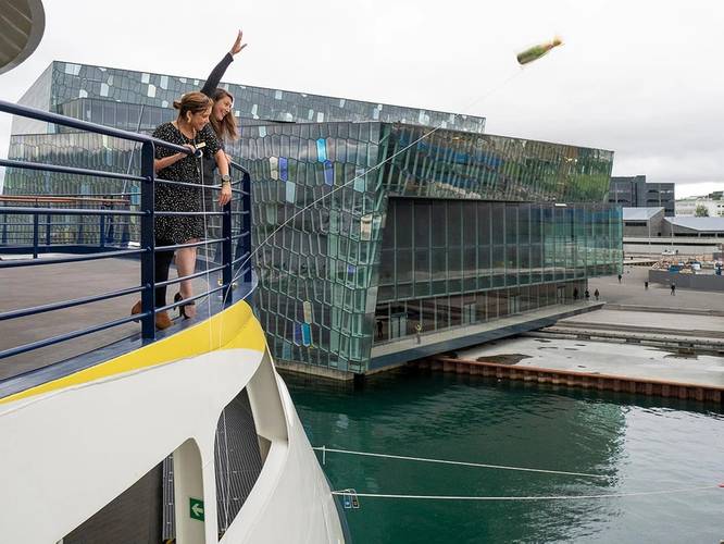 Jen Martin, Director of Field Staff & Expedition Development, and Ana Esteves, Director, Hotel Operations, toss the champagne bottle at the christening of National Geographic Endurance in Reykjavik, Iceland. 
Photo credit: Michael S. Nolan