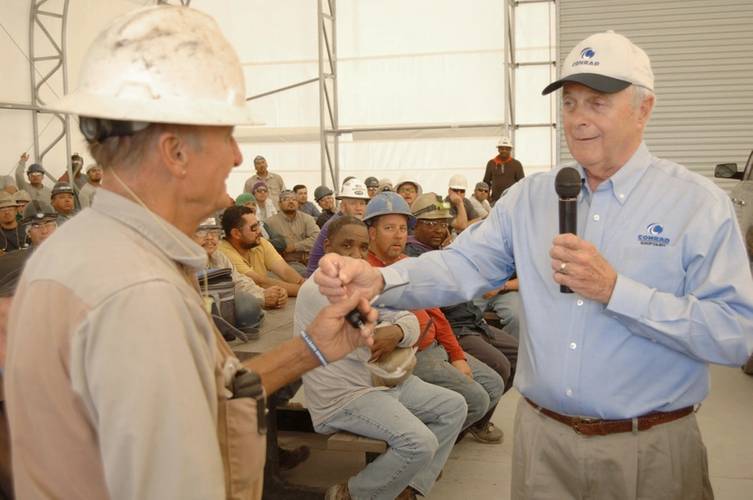 Johnny Conrad, Conrad Chairman and CEO, hands Johnny Kinkle the keys to his new boat. (Photo: Conrad Shipyard)