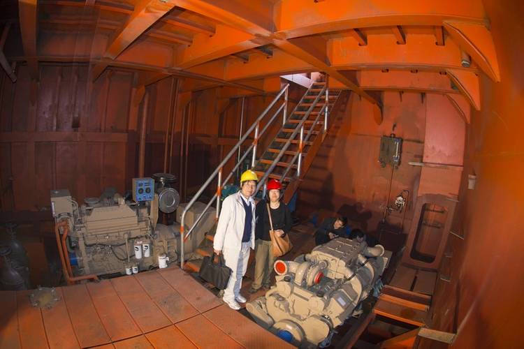 Liang Zhong De, deputy general manager, Guang Zhou Shun Fung Engineering Ltd.; stands with Cummins’ southern manager, Linda Zhang, in the starboard side engine room of the crane barge. The KTA19-D genset is to the left, and the KT38-m propulsion engine is to the right (Haig-Brown photo courtesy of Cummins Marine)