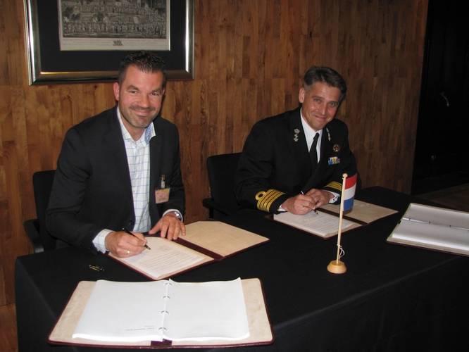 M C Jeronimus, Vice President of Goltens Europe, and Captain RNLN J F Kwak, Head Projects Procurement Division Ministry of Defense, sign the contract at The Hague (Photo: Goltens)