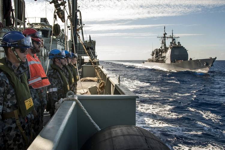 Members of HMAS Success's Ships Company turn and face outwards as the Ticonderoga Class Cruiser USS Port Royal makes her approach to conduct a RAS (Replenishment at Sea) off the coast of Hawaii (Photo: Brenton Freind)