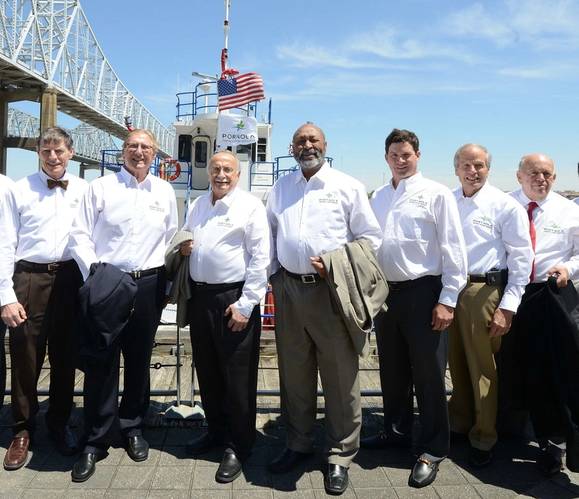 Members of the Board of Commissioners of the Port of New Orleans are joined by Port President and CEO Gary LaGrange wearing shirts with the port's new logo while the new port flag flies above the Gen. Roy S. Kelley fireboat. Pictured Commissioner Joseph F. Toomy, Mr. LaGrange, Commissioner William T. Bergeron, Board Chairman Daniel F. Packer, Board Secretary-Treasurer Scott H. Cooper, Commissioner Michael W. Kearney and Commissioner Robert Barkerding Jr.