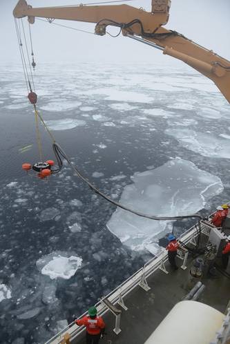 Members of the Coast Guard Cutter Healy deck department lower an oil skimmer into the ice-laden Beaufort Sea. Multiple Coast Guard units and partner agencies and organizations, coordinated by the Coast Guard Research and Development Center, cooperated to accomplish the exercise, which explored the potential for present technology to respond to an oil spill in the extreme Arctic environment. (U.S. Coast Guard photo by Petty Officer 3rd Class Grant DeVuyst)