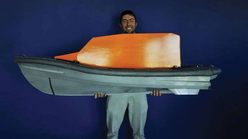 Naval architect Peter Eyre with his model of the Shannon lifeboat’s hull. (Photo: RNLI/Nigel Millard)
