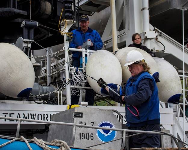NOAA ships spent the last several days preparing for their Arctic missions. Here, Chief Bosun Jim Kruger (front) works with Jason Kinyon and Lindsey Houska on NOAA Ship Rainier as they get ready to depart this week for the summer's first Arctic survey project, in Kotzebue Sound.(Credit: NOAA)