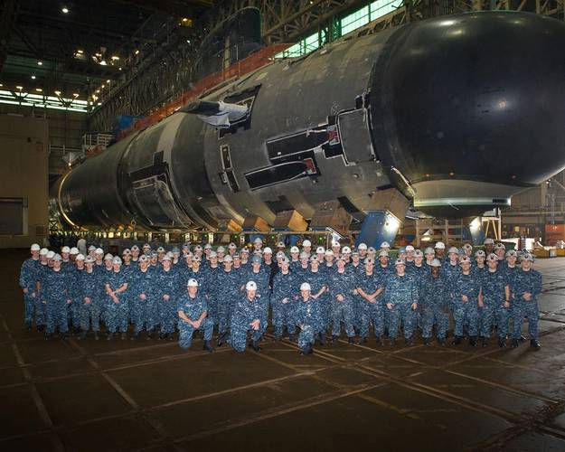 Officers and crew pose in front of submarine Illinois in November 2014 as the forward section of the submarine is moved to mate with the aft section. (Photo: General Dynamics Electric Boat)