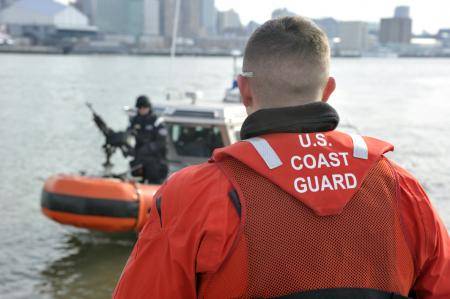 Petty Officer 2nd Class Brad Haines communicates with a maritime safety and security team member during a patrol on the Hudson River. U.S. Coast Guard photo by Petty Officer 3rd Class Michael Himes.