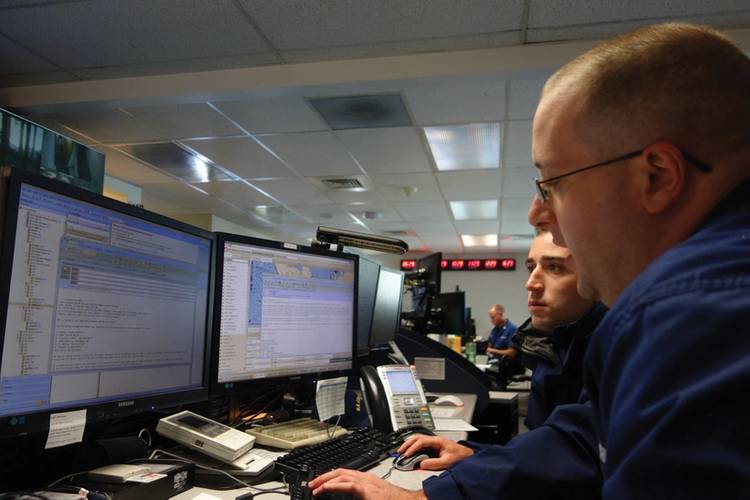 Petty Officer Charles Testrake trains Petty Officer Jesse Cappella in the art of responding to GPS-related inquiries. On average, NAVCEN fields over 22,900 inquiries submitted by the public through the NAVCEN website annually.