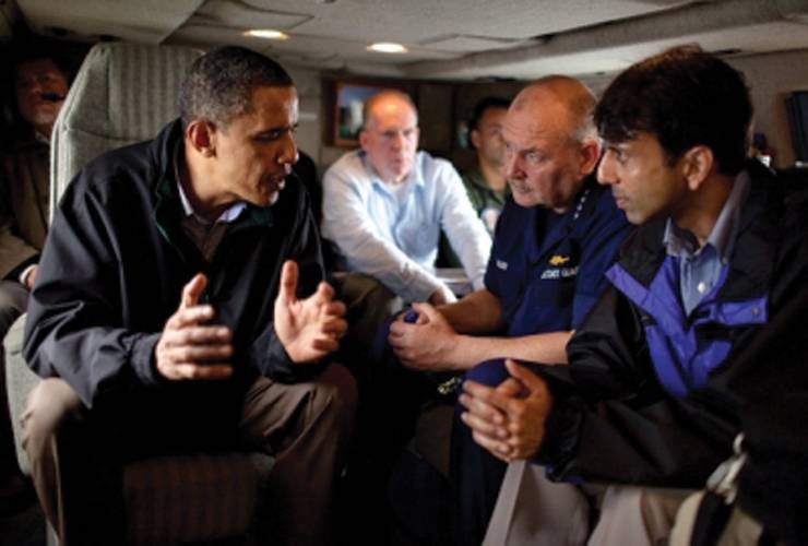 President Obama talks with Coast Guard Admiral Thad Allen, who was also the National Incident Commander for the Deepwater Horizon oil spill (center), and Louisiana Gov. Bobby Jindal aboard Marine One as they fly along the coastline from Venice, La., to New Orleans on May 2, 2010. White House Photo by Pete Souza