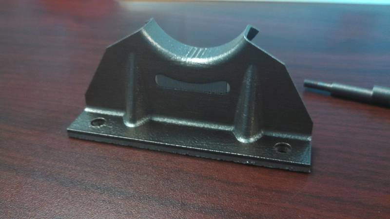 This prototype pump bracket for the H-65 medium range surveillance helicopter was printed by the U.S. Navy in collaboration with the Aviation Logistics Center in Elizabeth City, N.C. (U.S. Coast Guard photo by Bill Bryan)