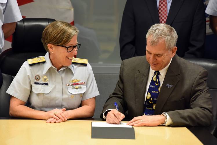 Rear Adm. Joanna Nunan, Coast Guard Ninth District commander, and James Weakley, Lake Carriers' Association president, sign a memorandum of agreement for maritime industry rescue training in Cleveland, Ohio, Oct. 31, 2017. (U.S. Coast Guard photo by Lauren Steenson)